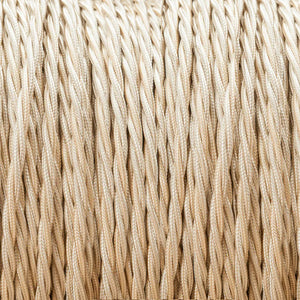 A close-up of tightly twisted beige or cream-colored cords/rope filling the frame, showing a fine woven texture.