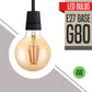 A vintage-style E27 4W G80 LED bulb with a black base, designed to fit standard E27 sockets, presented with a warm white light effect.